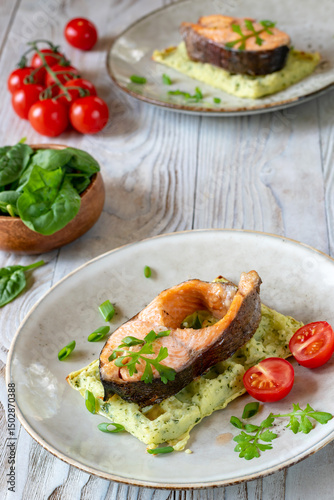 Trout on potato waffle with spinach.