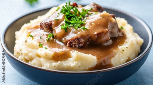 A hearty dish featuring meatloaf smothered in rich gravy, served over fluffy mashed potatoes, exemplifying comfort food at its finest in a rustic kitchen setup.
