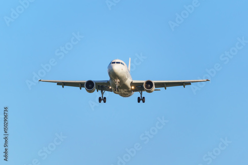 Passenger airplane preparing to land. Blue background. Isolated on blue.