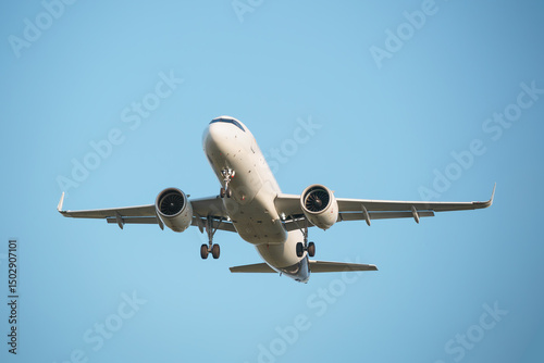 Passenger airplane is preparing to land at the airport. Blue background.