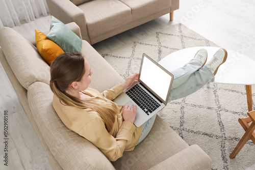 Young woman using blank lap...