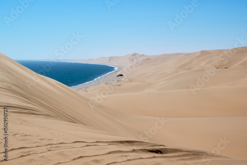 Fototapeta Naklejka Na Ścianę i Meble -  SAND DUNES AND OCEAN IN NAMIBIA