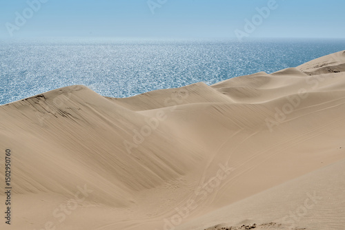 Fototapeta Naklejka Na Ścianę i Meble -  SAND DUNES AND OCEAN IN NAMIBIA