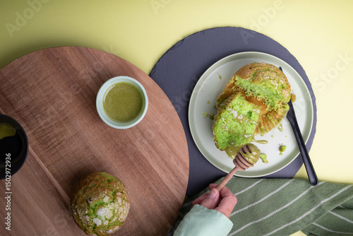 Green tea muffins with whipped matcha honey, hand holding dipper
