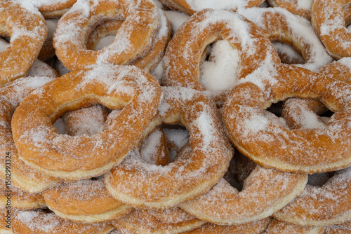 Fototapeta Naklejka Na Ścianę i Meble -  Traditional Greek doughnuts are a pastry and popular street food snack sold from street carts and bakeries in Greece, a tasty sweet desert