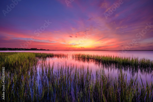 Wall Mural Colorful clouds before sunrise in the marsh in Beaufort, NC