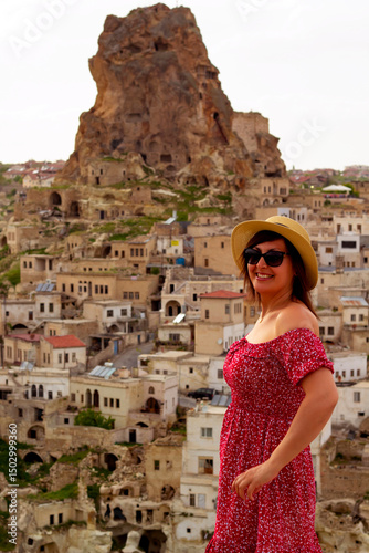 beautiful woman in a white hat looking to the view of cappadocia, turkey	