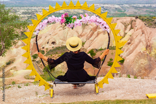 beautiful woman in a white hat looking to the view of cappadocia, turkey	