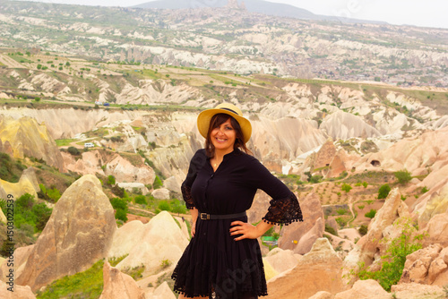 beautiful woman in a white hat looking to the view of cappadocia, turkey	