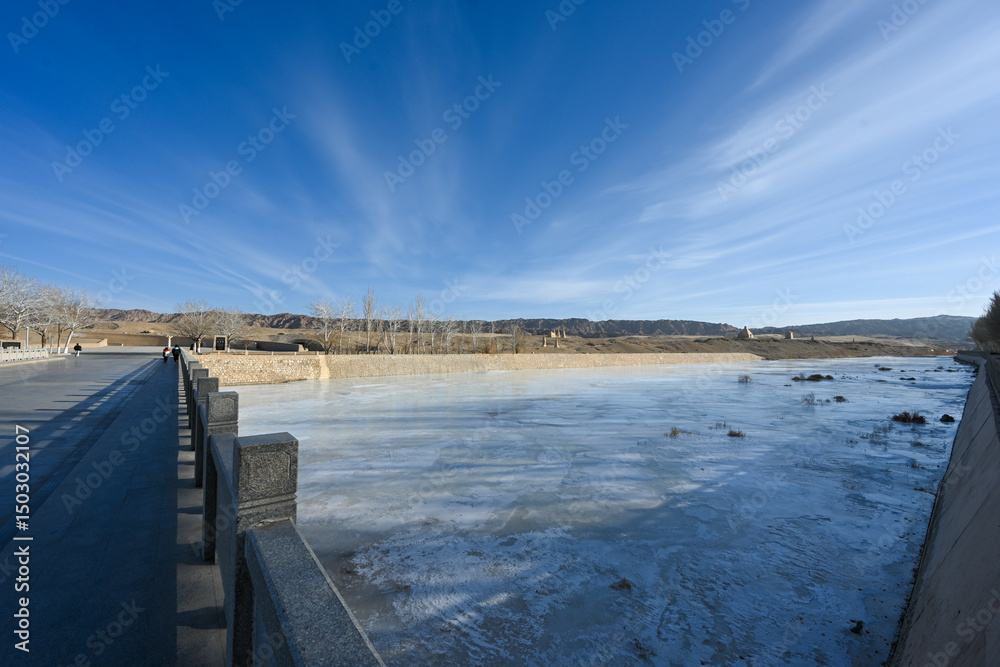 Naklejka premium Frozen River in Winter with Clear Sky