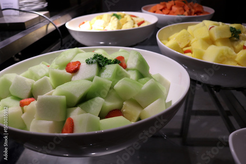 Photo of various pieces of very fresh and sweet fruit on a restaurant plate.