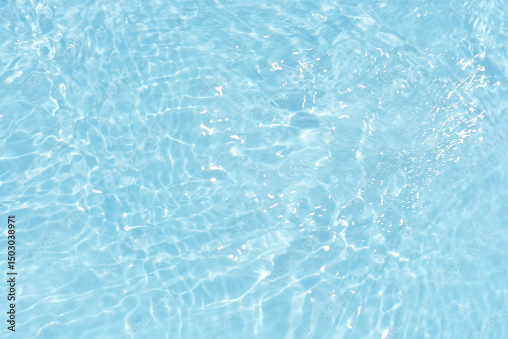 Obraz premium Blue water with ripples on the surface. Defocus blurred transparent blue colored clear calm water surface texture with splashes and bubbles. Water waves with shining pattern texture background.
