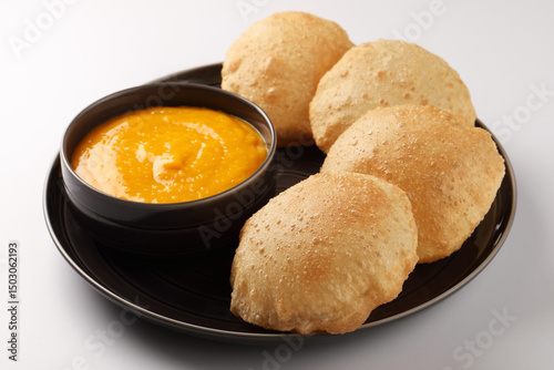 Indian Food - Aamras is a sweet dish made from the pulp of the Alphonso mango fruit. Served with hot puri/poori. Sweet Mango puree garnished with Kashmiri Saffron. Aam Ras Puri OR Alphonso Mango