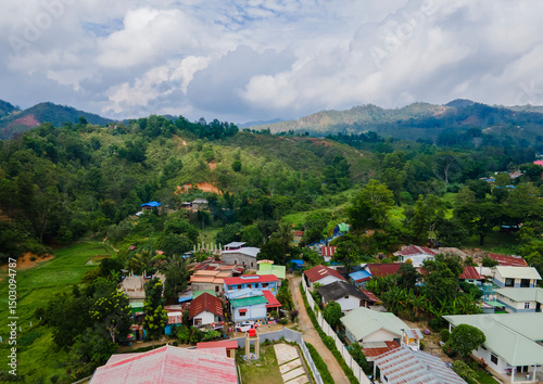 Aerial view of residential area with hills and mountains in the background in Aileu Villa district, urban area in Aileu Municipality, Timor Leste.