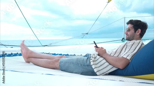 A young man is enjoying his seaside adventure aboard a yacht