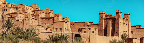 Panoramic view of Ait Benhaddou, a World Heritage site in Morocco, showcasing traditional earthen architecture against a vibrant blue sky