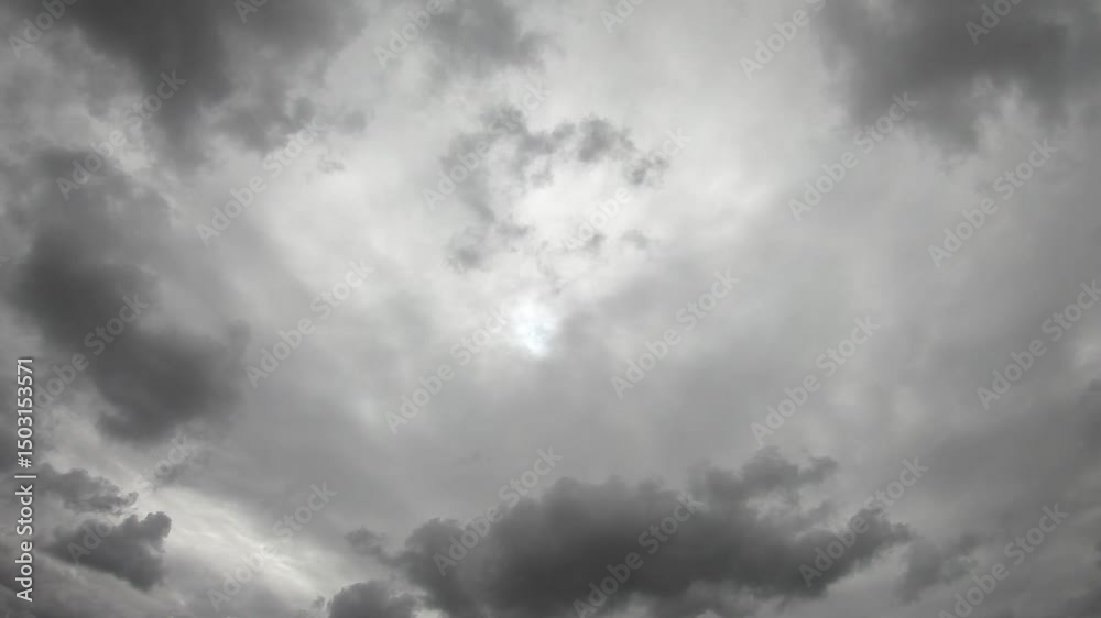 Dark clouds moving quickly across sky at daytime time lapse