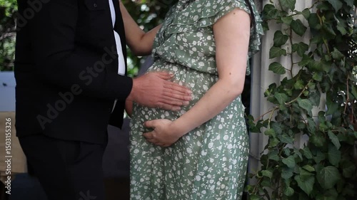 Moms pregnancy dad gently touches mom belly waiting for the baby