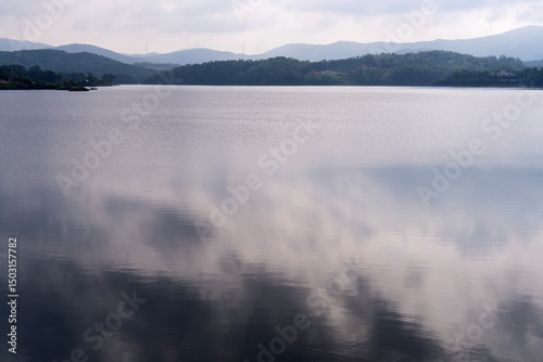 calm lake with mountain and cloud reflection in the morning
