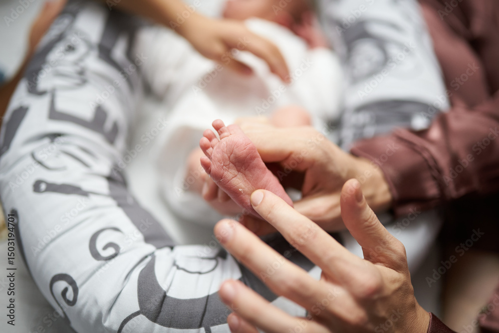 Fototapeta premium relatives want to pet the baby at home, affection in the family for a newborn boy