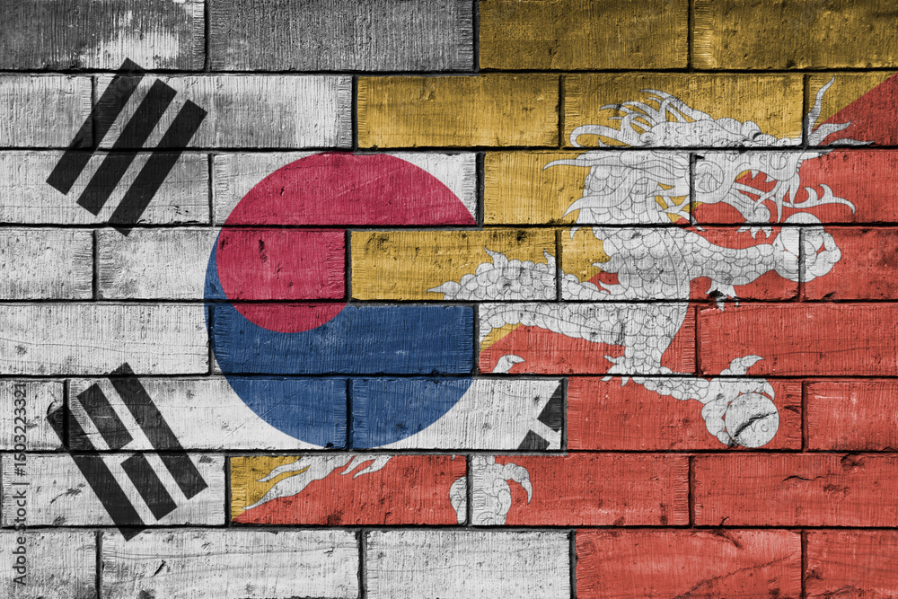 Fototapeta premium colourful painted big national flag of south korea and flag of bhutan on a massive old brick wall background. concept