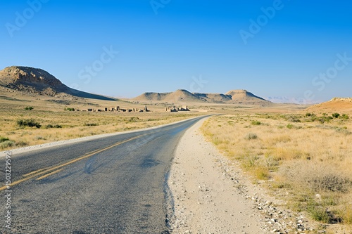 Deserted Highway Leading To Ancient Ruins In Arid Landscape
