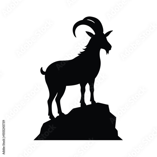 Silhouette of a majestic mountain goat standing proudly atop a rocky outcrop