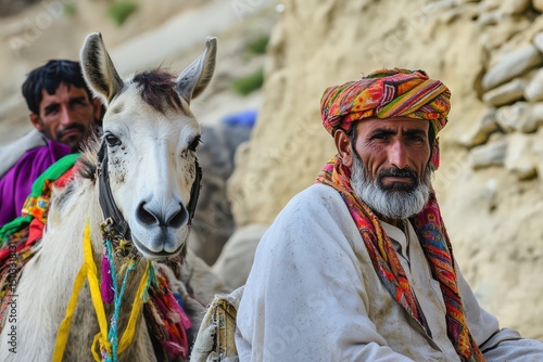 Men riding horses in mountainous terrain