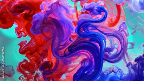 Vibrant colored paint drops mixing in liquid creating abstract swirling underwater patterns. The pigments blend smoothly forming organic flowing movements