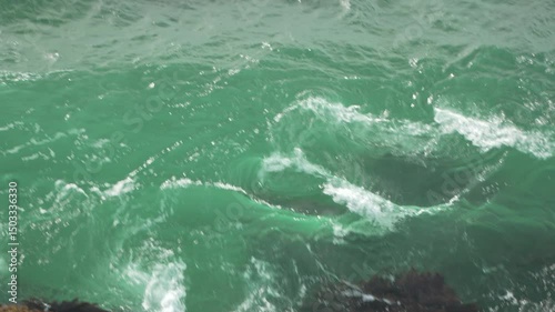 Waves water ocean motion, Daytime ocean waves crash, creating seafoam, and swirling patterns.