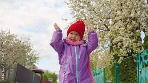 Cute girl child toddler enjoys spring cherry blossoms. Samara, Russia - 15 Apr 2025