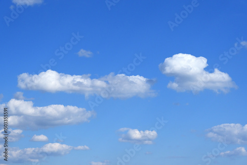 Fluffy white clouds in a clear blue sky