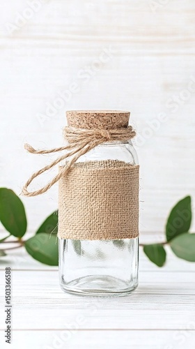 Rustic Small Glass Mason Jar with Burlap and Twine on White Wooden Background