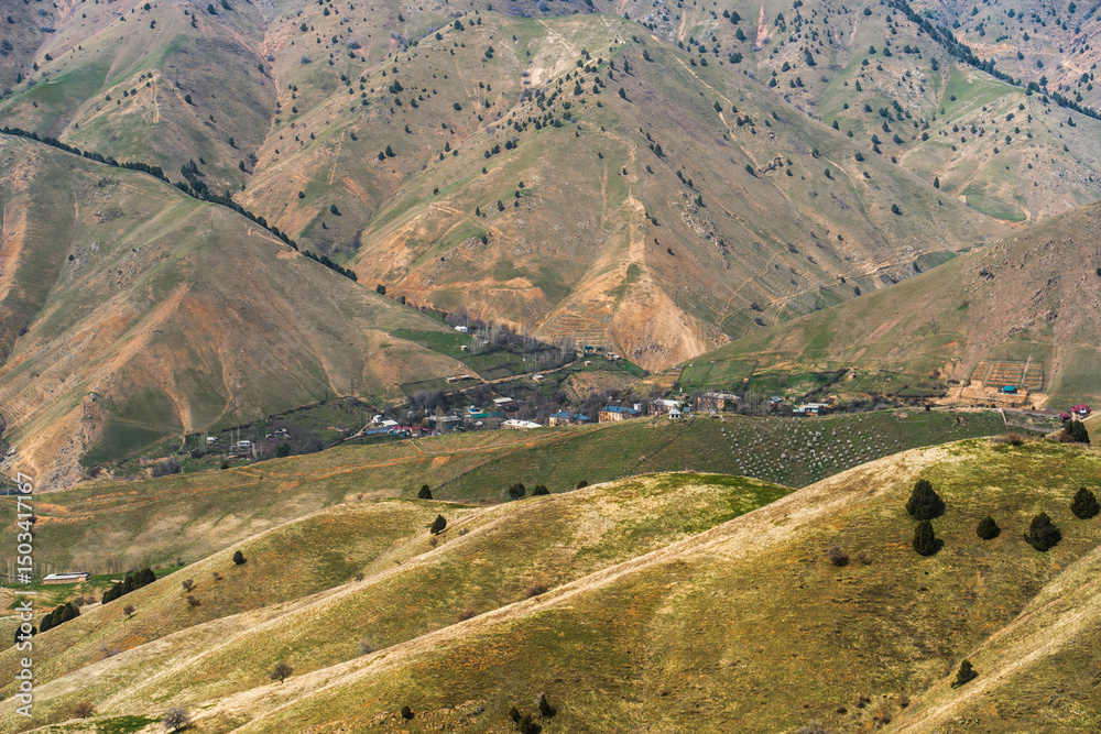 Fototapeta premium Spring photo of Uzbek ex-mining town Yangiabad taken from the nearby slopes of Tian Shan.