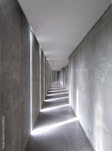 Minimalist architecture corridor with concrete columns and dramatic linear light patterns. Modern, geometric symmetry perfect for design, background, and abstract themes.