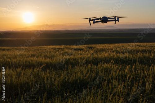 silhouette of a drone flying to help with the efficient cultivation of agricultural crops