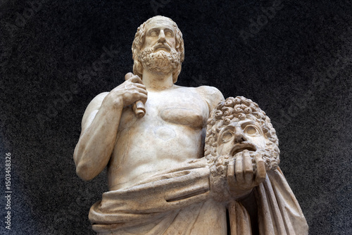 Marble statue of ancient Greek tragic poet Euripides holding a theatrical mask, symbolizing classical drama, intellect, and cultural heritage. photo