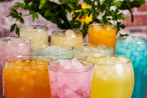 Εκτύπωση καμβά Top view close-up of multiple glasses filled with ice and colorful soft drinks of various flavors