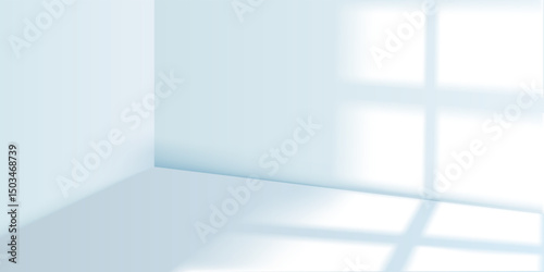 Empty room with soft light and shadow from windows on the walls and light blue floor. Interior of a minimalist studio. Soft abstract background for product presentation.