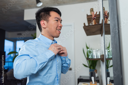 A young man getting dressed for work