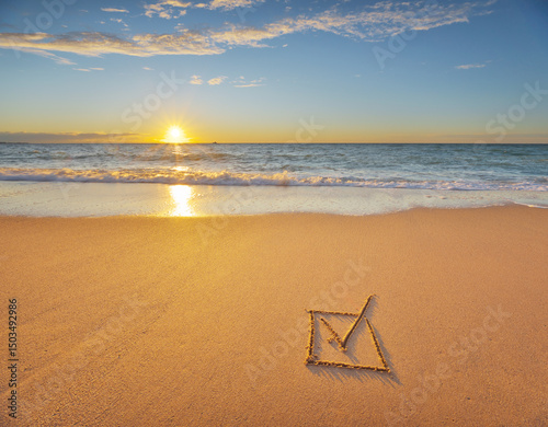 Check mark symbol in box on the beach shore during the sunset.