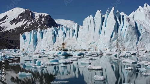 Majestic glacier calving: massive iceberg splitting into pristine arctic waters