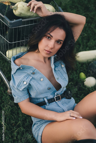 A beautiful woman in the village stands near the squash harvest. Agricultural industry. Tinting