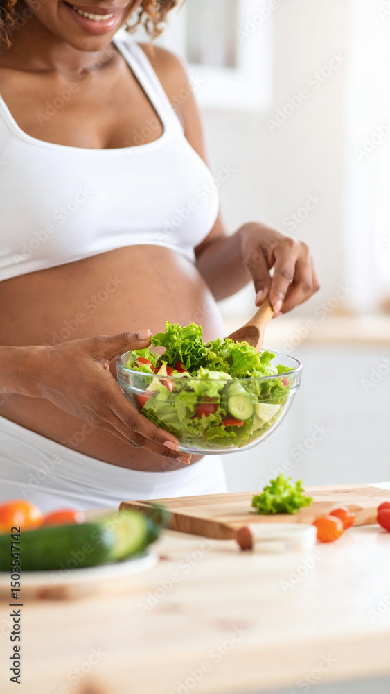 A pregnant woman in a white top is preparing a fresh vegetable salad in a bright kitchen, focusing on maintaining a healthy diet for her baby’s well-being. A pregnant woman in a white top is preparing a fresh vegetable salad in a bright kitchen, focusing on maintaining a healthy diet for her baby’s well-being.
