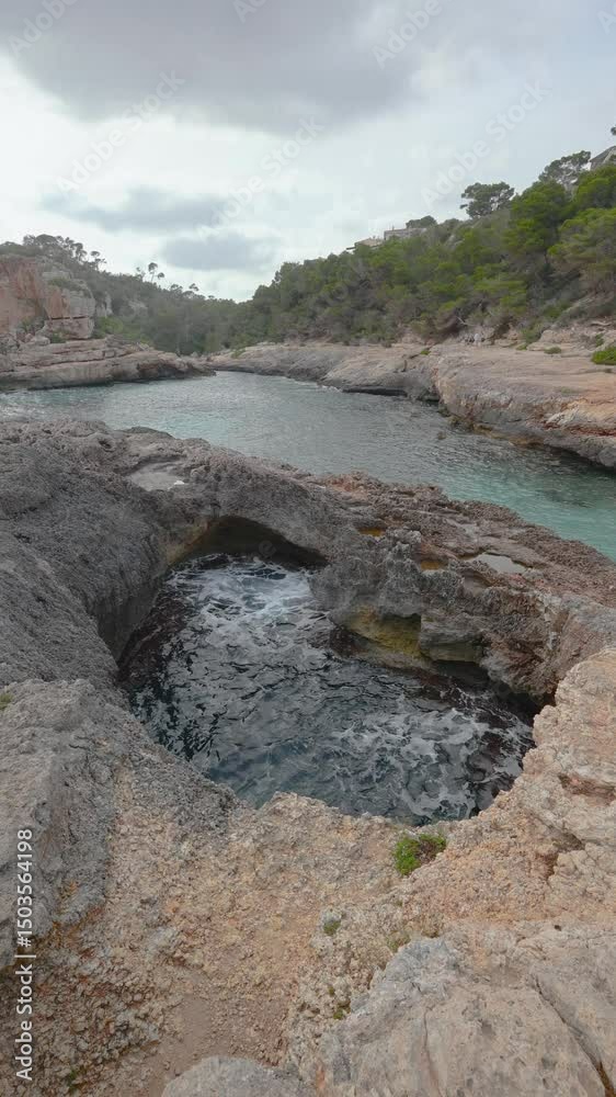 Picturesque cala s'almunia in mallorca showing turquoise waters, houses and lush vegetation Picturesque cala s'almunia in mallorca showing turquoise waters, houses and lush vegetation