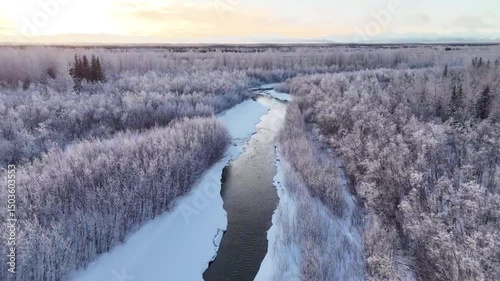 Aerial view of a snowy river landscape.