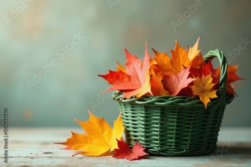 Autumnal Leaves in a Green Wicker Basket on a Rustic Wooden Surface
