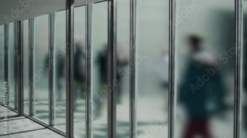 Looping background of people walking in Tokyo Station, People Silhouettes Walking Behind Frosted Glass Wall