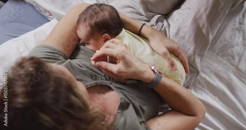 Video of happy caucasian mother feeding newborn baby