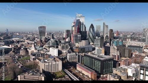 Modern skyscrapers in City financial and economic district. Red tower cranes on new building construction site. London, UK